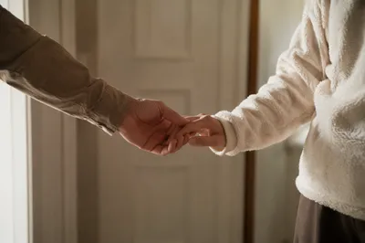 Forgiveness Hands in Warm Hallway Light