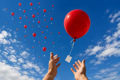 Hands Releasing Red Balloons of Forgiveness