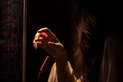 Forgiveness Hand Releasing Red Marker in Light