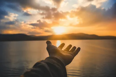Open Hand Releasing Burdens at Sunset