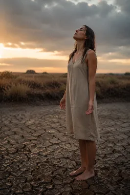 Young Woman in Rain on Dry Field