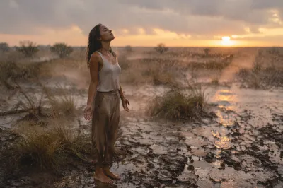 Woman in Rain Over Dry Field