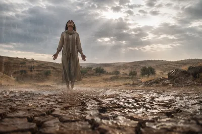 Woman in Rain Over Cracked Earth