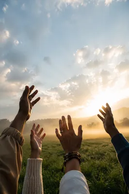Hands Raised to Sunrise Sky in Freedom
