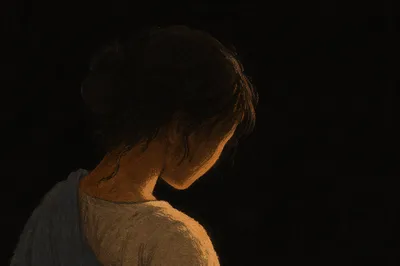 Bowed Head in Gentle Amber Light