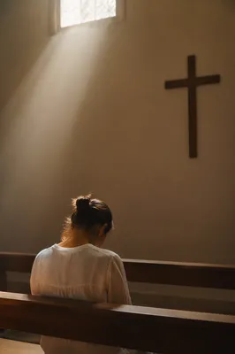 Bowed Prayer in Gentle Chapel Light