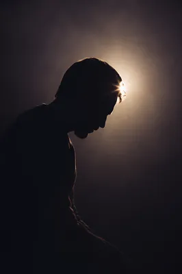 Humble Bowed Silhouette in Gentle Light