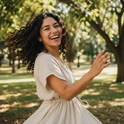 Joyful Woman Twirling Under Sunlit Trees