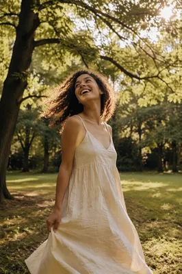 Joyful Woman Twirling in Sunlit Park
