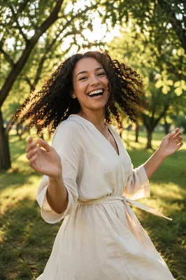 Joyful Woman Beneath Sunlit Park Trees