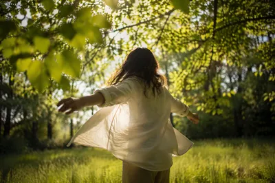 Joyful Twirl Beneath Sunlit Spring Leaves