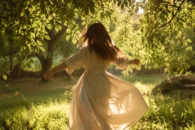 Joyful Sunlit Dance Beneath Green Leaves