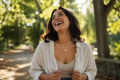 Joyful Woman Under Sunlit Park Trees
