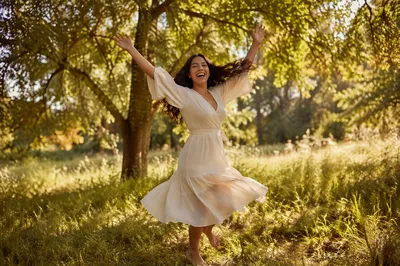 Joyful Woman Twirling in Sunny Meadow