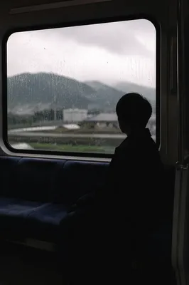 Lonely Silhouette by Rainy Transit Window