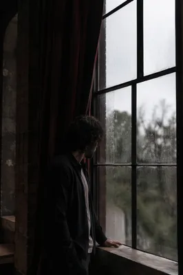 Lonely Figure by Rainy Loft Window