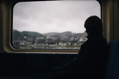 Lonely Silhouette by Rainy Transit Window