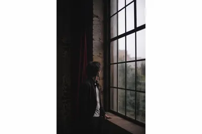 Lonely Figure by Rainy Loft Window