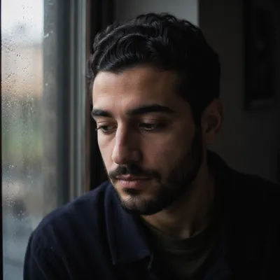 Reflective Young Man by Rainy Window