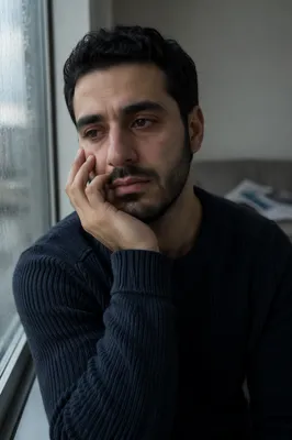 Tearful Young Man by Rainy Window