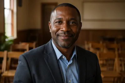 Smiling Middle-Aged Man in Sunlit Hall