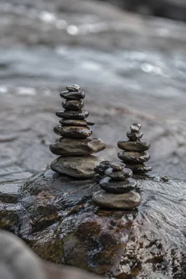 Peaceful Stone Cairns by Still Water