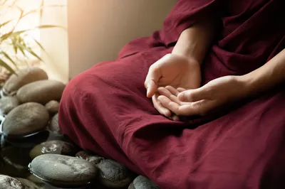 Peaceful Hands Beside Still Water Stones