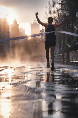 Runner Crossing Finish Line at Dawn