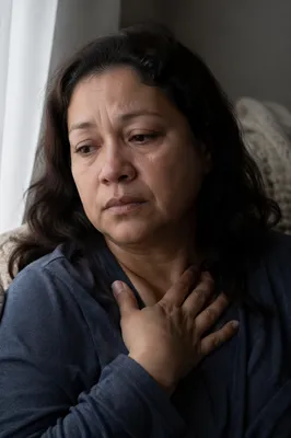 Grieving Woman by Softly Lit Window