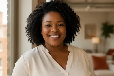 Confident Smiling Woman by Apartment Window