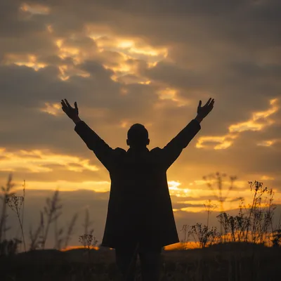 Praise Hands Raised Beneath Golden Sunset