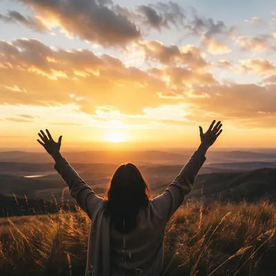 Praise Hands Lifted at Golden Sunset