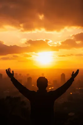 Praise Hands Lifted at Golden Sunset