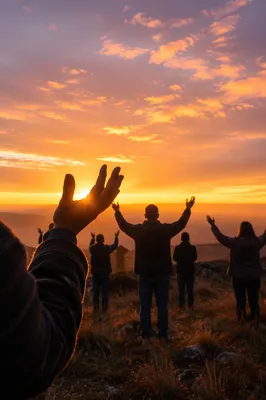 Raised Hands at Golden Sunset Sky
