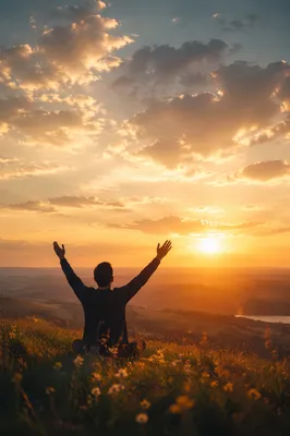 Silhouetted Figure with Raised Arms at Sunset