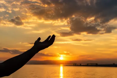 Praise Hand Raised Toward Golden Sunset