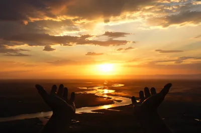Praise Hands Raised Over Golden Sunset River