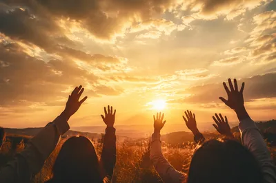 Praise Hands Lifted Under Golden Sunset