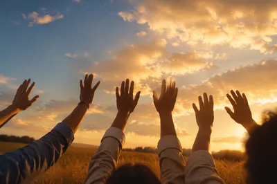 Praise Hands Lifted in Golden Sunset