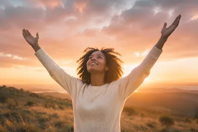 Woman Raising Hands at Sunset Sky