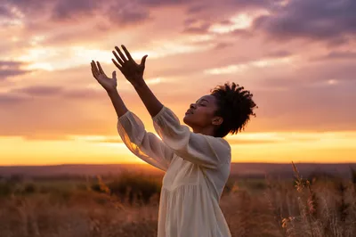 Woman Lifting Hands at Golden Sunset