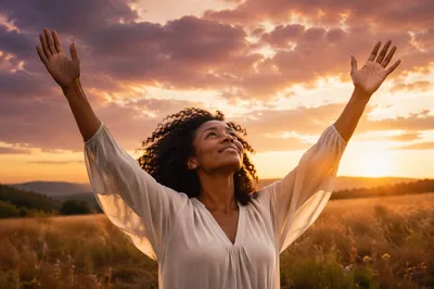 Woman Raising Hands at Sunset Meadow