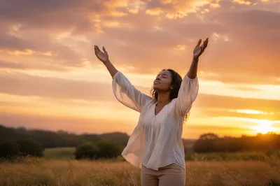 Woman Lifting Hands at Sunset Field
