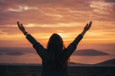 Praise Hands Raised at Golden Sunset