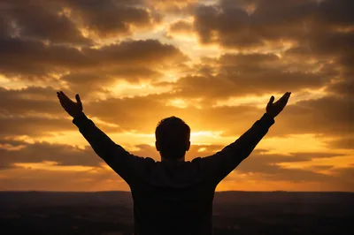Silhouetted Praise Hands Under Golden Sunset