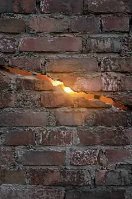 Redemption Sunrise Through Broken Brick Wall