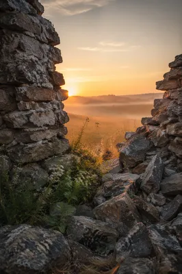 Sunrise Through Broken Stone Wall