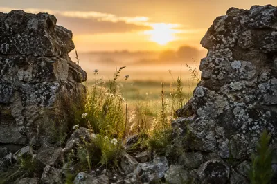 Sunrise Through Broken Stone Wall