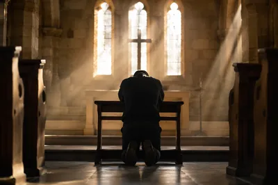 Kneeling in Repentance Before the Cross