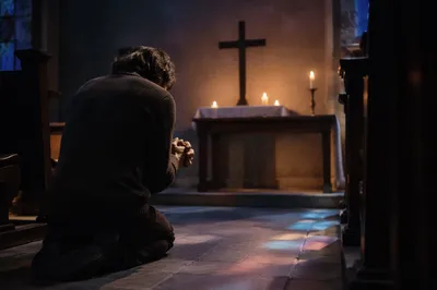 Kneeling in Repentance Before Church Altar